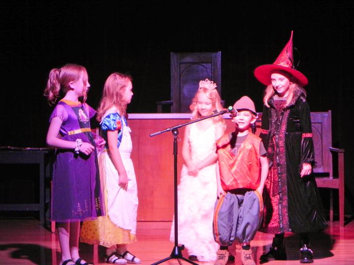 Five children on stage in costume.