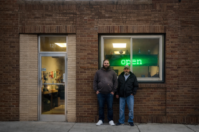 Pat Blankenship and Chris Dailey stand outside Downtown Deal, a liquidation retail store at 121 N. Center St. in downtown Lake City. 