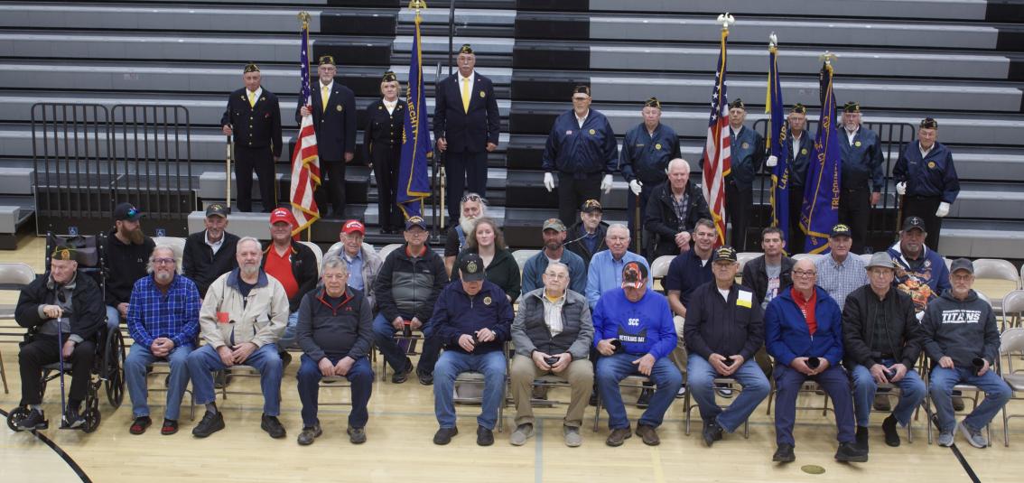 The veterans pose in the gym.