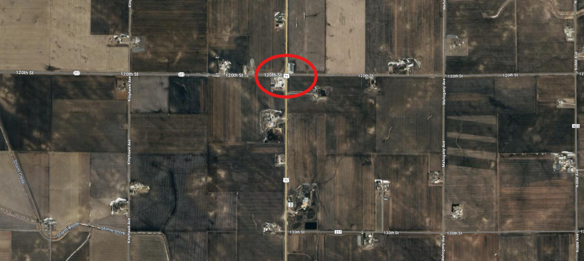 A screenshot of Google Maps satellite view of the intersection where the accident occurred. The intersection is circled in red.