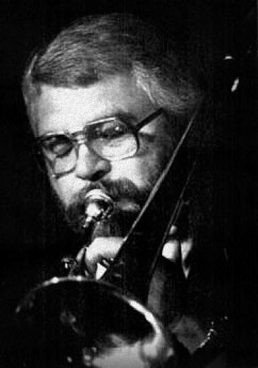  A close-up black and white photo of Bauman playing the trombone.