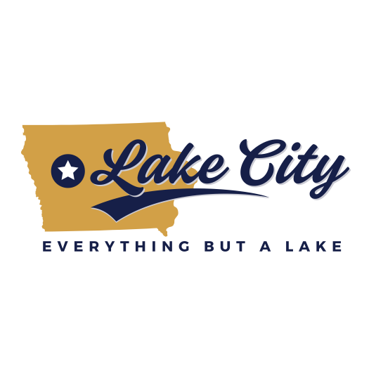 The shape of Iowa, filled in with a dark gold color. There is a navy blue and white star marking Lake City's location in the state. The words "Lake City: Everything but a lake" are in dark navy blue.