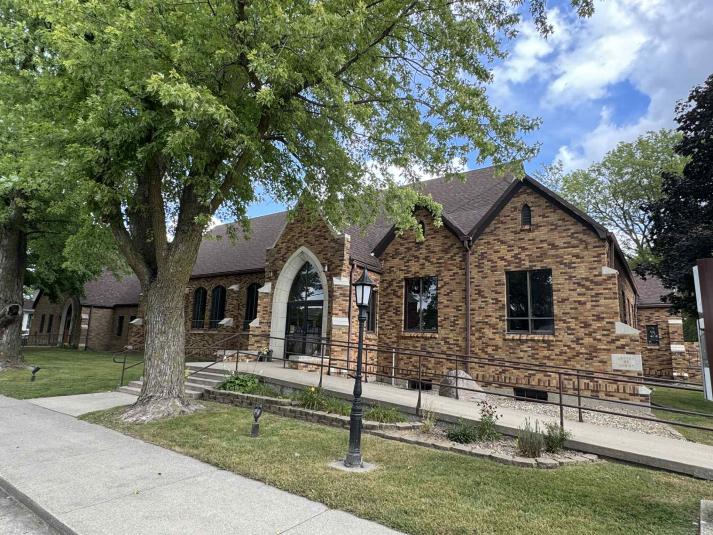 An exterior shot of the church, a brown brick building.