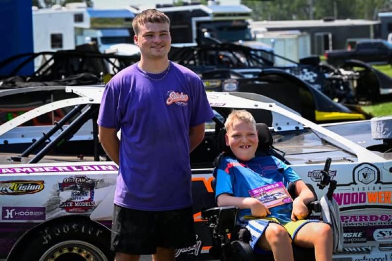 Chamberlain and Wuebker pose in front of Chamberlain's racecar. 